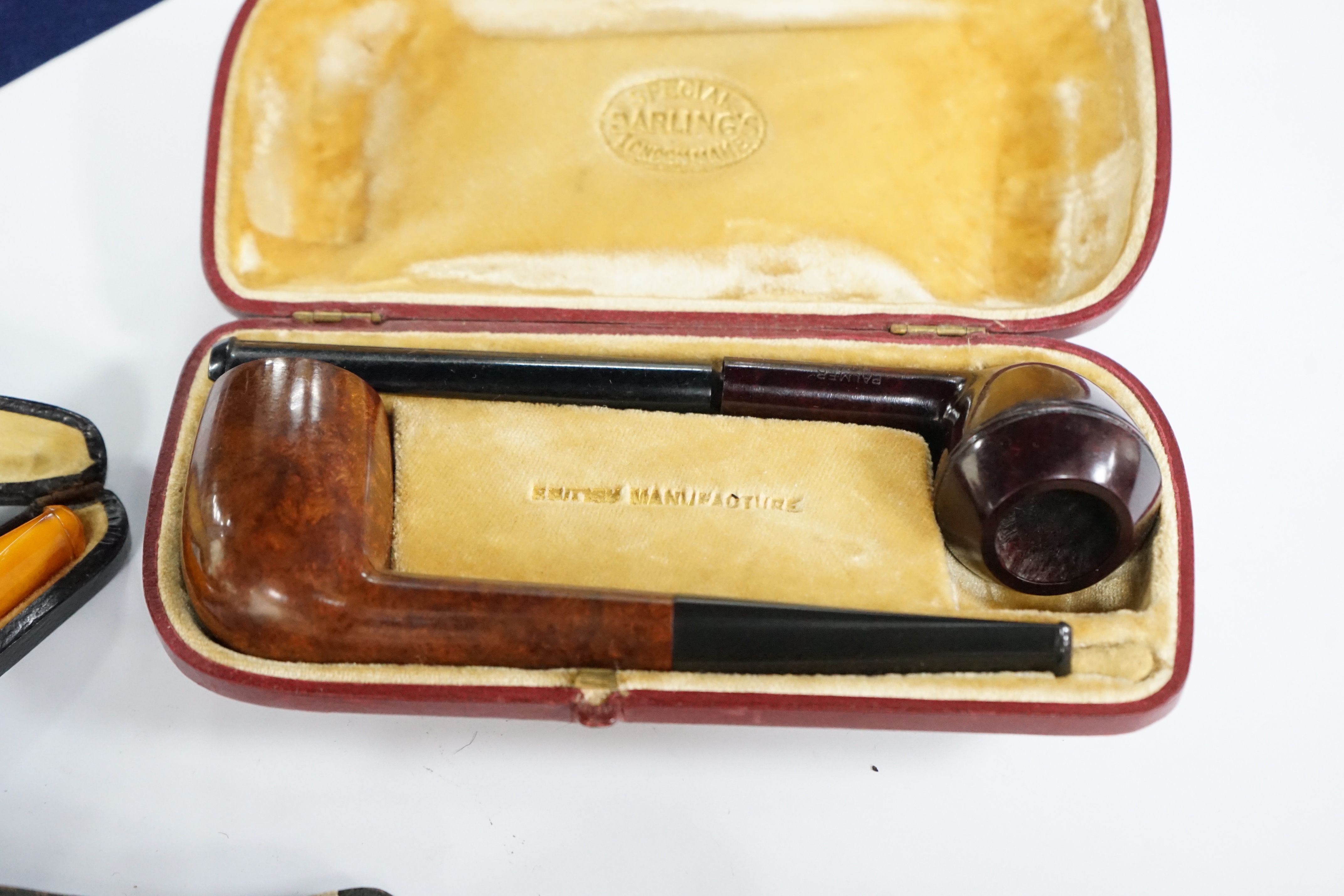 Seven cased pipes in varying sizes, some with amber mouthpieces, largest 19cm long